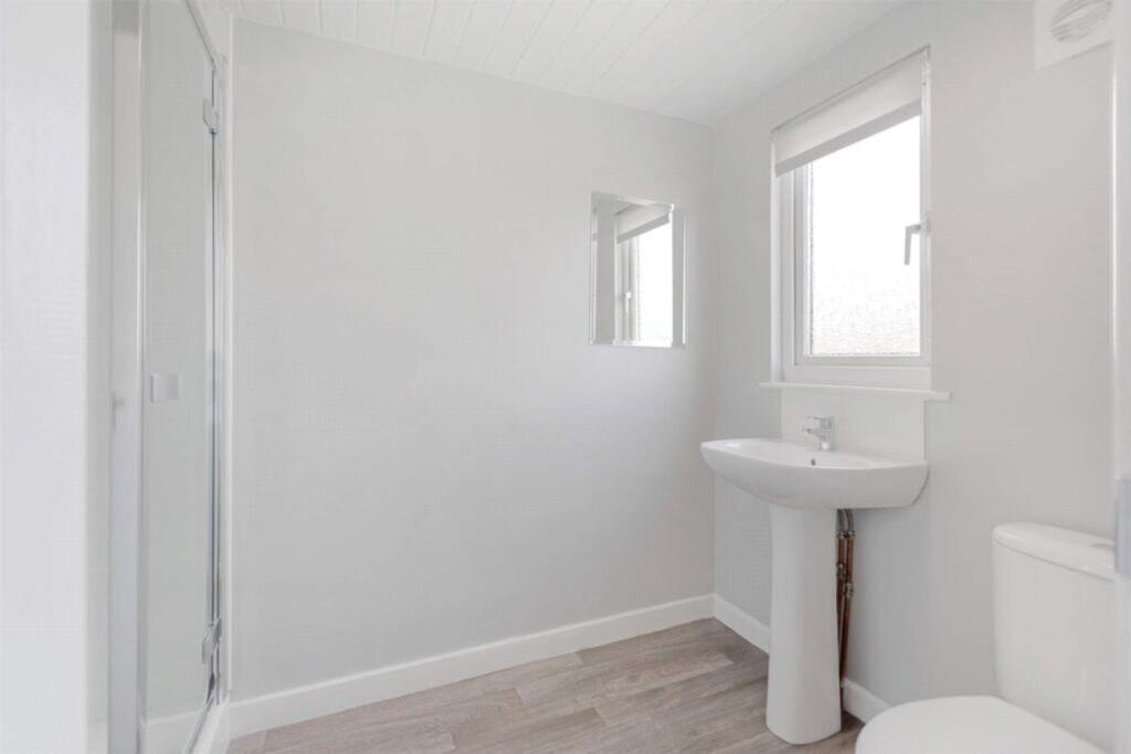 A bright and modern bathroom featuring a sleek ...