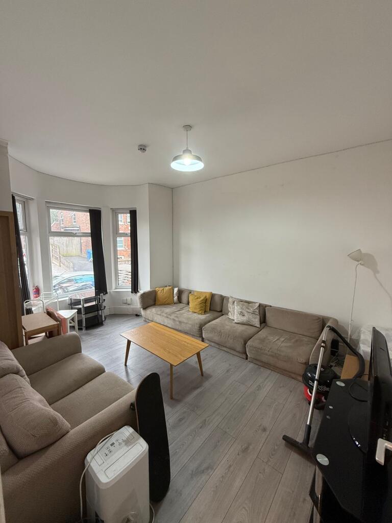A cozy living room featuring a large L-shaped s...