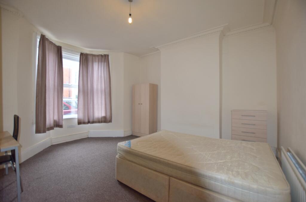 A spacious and bright double bedroom with large...