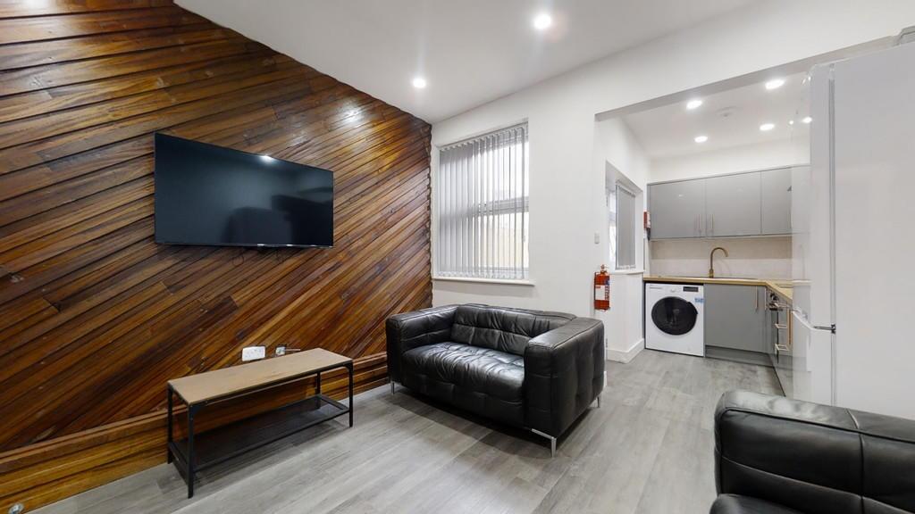 A modern living room featuring stylish dark lea...