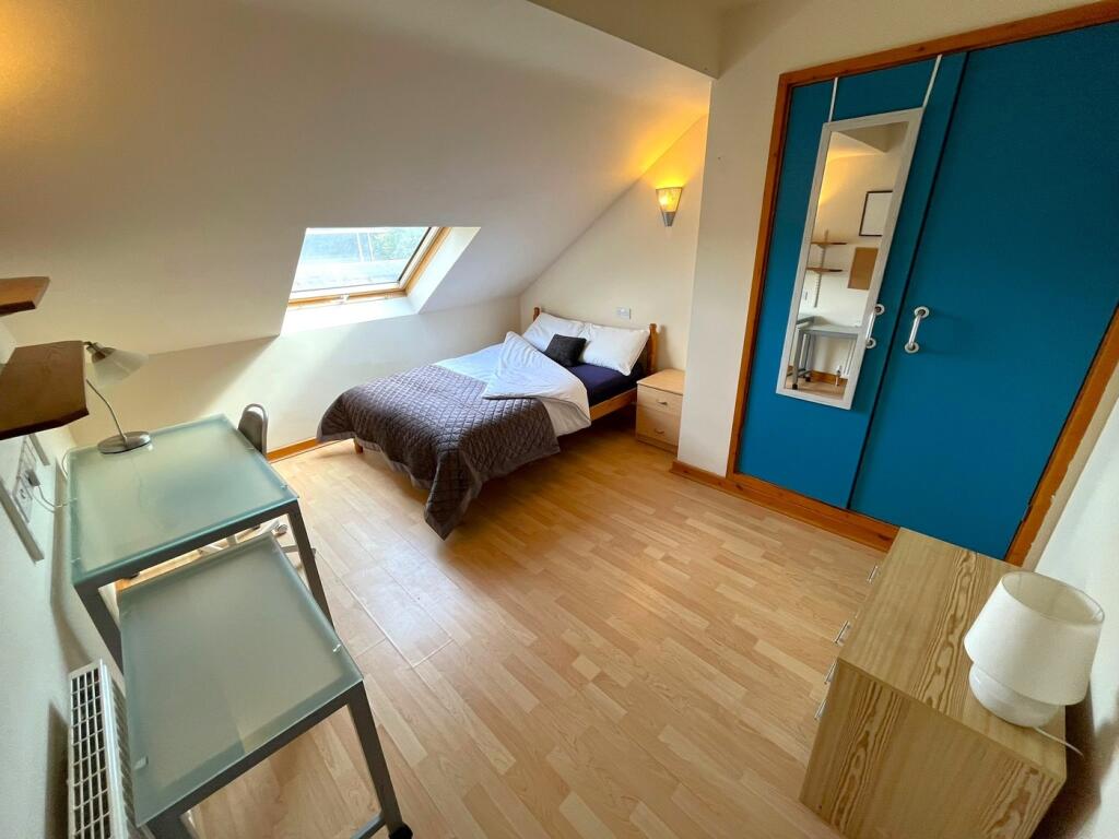 A bright and inviting double bedroom with ample...