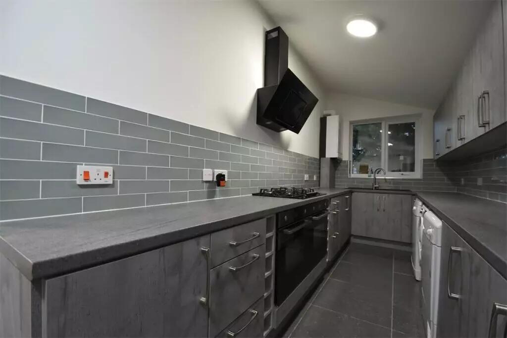 Modern, well-maintained kitchen featuring sleek...