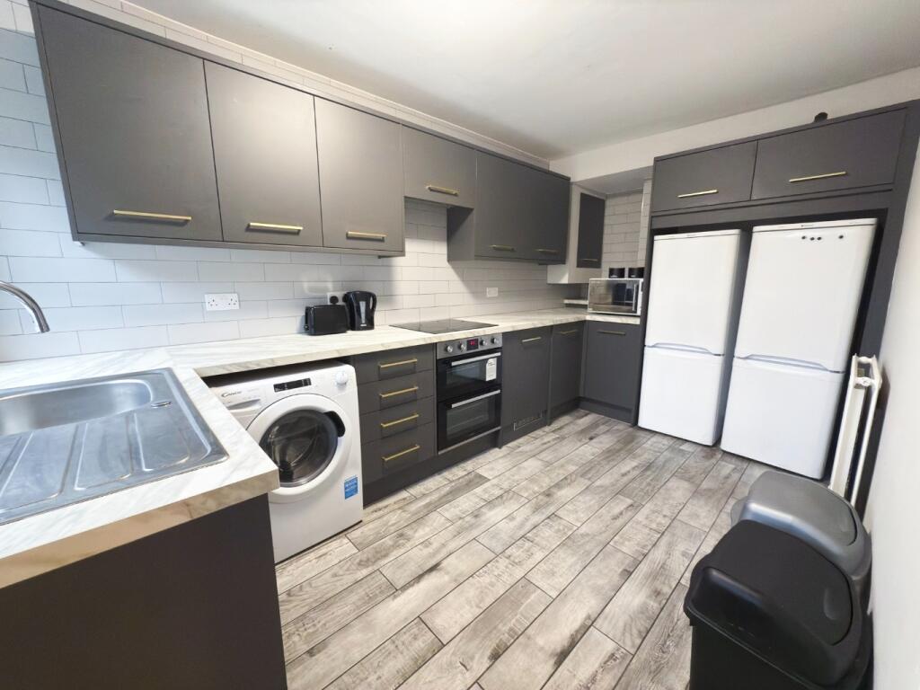 Modern, well-maintained kitchen with ample stor...