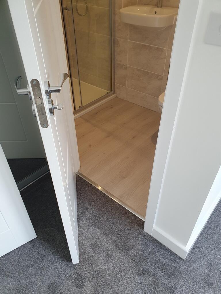 Bright and modern bathroom featuring sleek fixt...