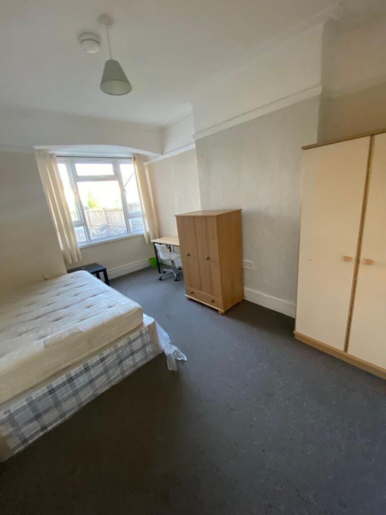 Spacious double bedroom featuring large windows...