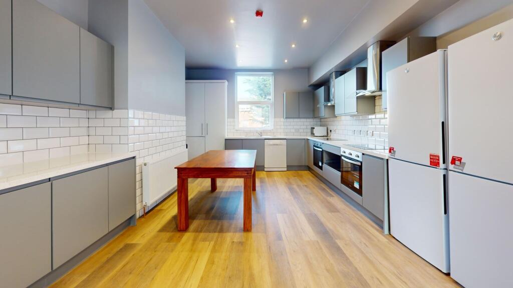 Bright and modern kitchen with ample natural li...