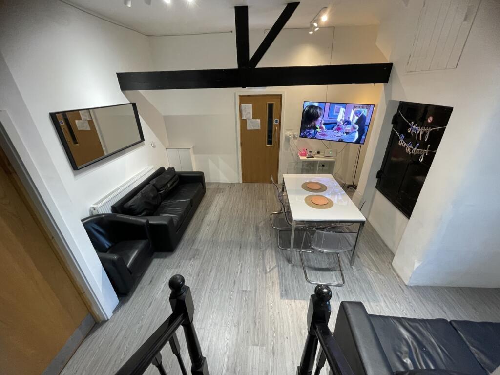 Contemporary living room featuring a sleek blac...