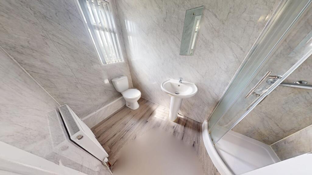 A modern bathroom suite featuring a spacious sh...