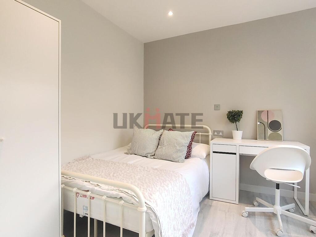 Bright and clean bedroom featuring a white bed ...