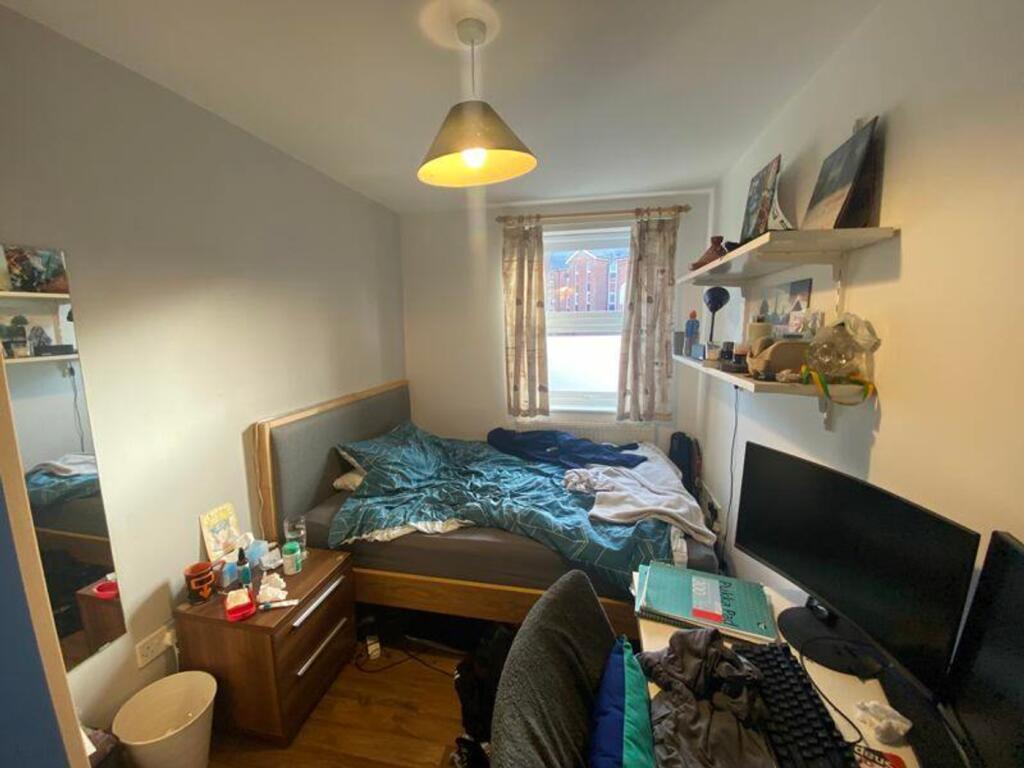 A cozy double bedroom with ample natural light ...