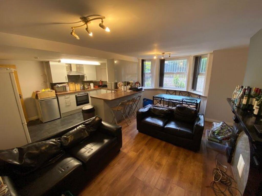 Spacious and modern open-plan living room featu...