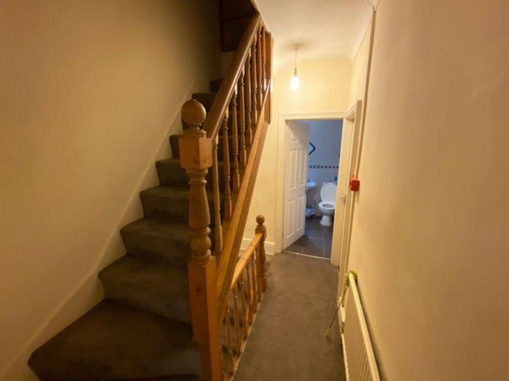 A clean and well-maintained hallway featuring a...