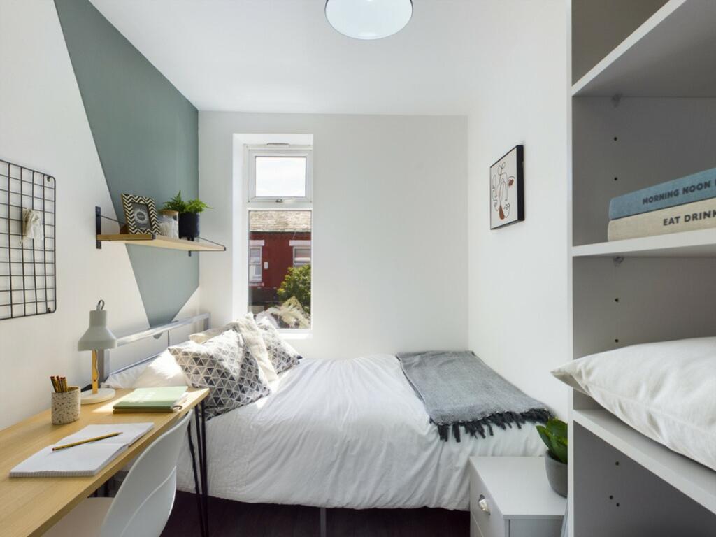 A bright and cozy double bedroom with modern de...