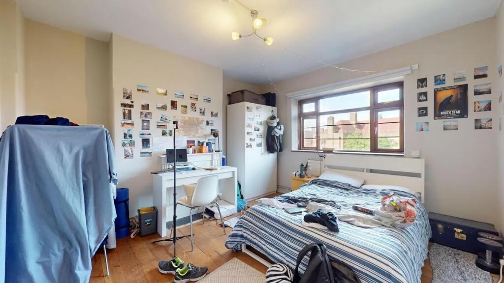 Bright and spacious bedroom featuring a large w...