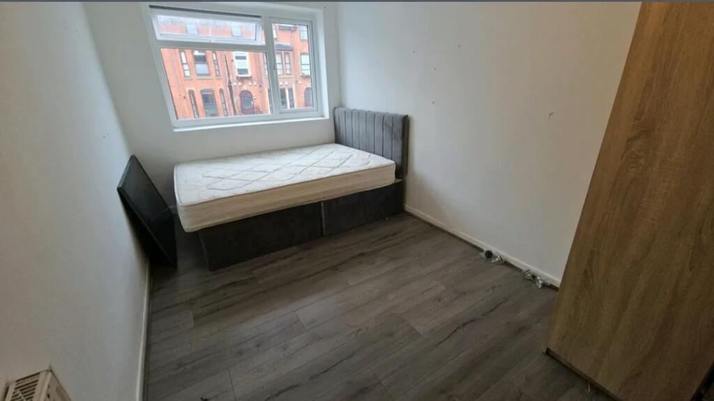 Bright and spacious double bedroom featuring la...