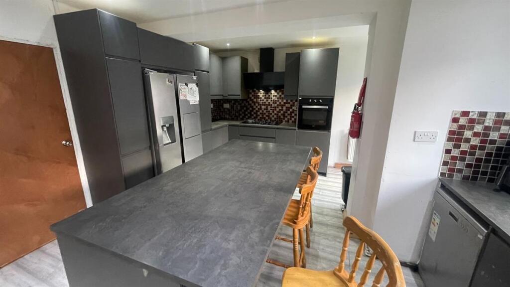 Modern kitchen with a long island breakfast bar...