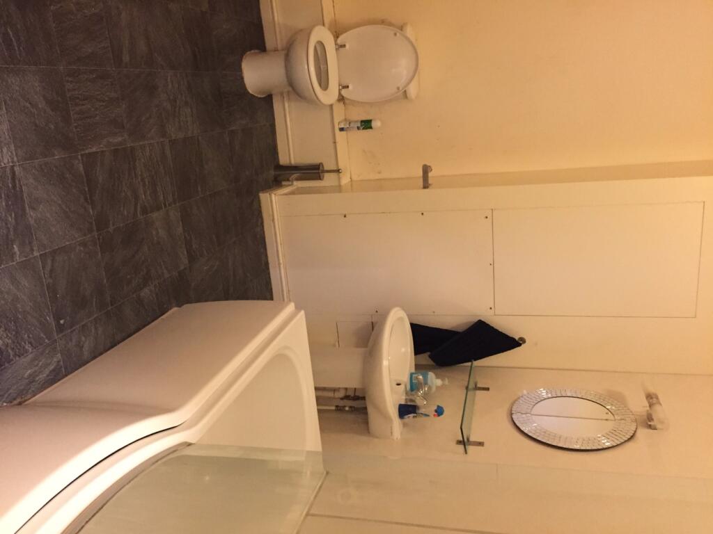 Spacious bathroom featuring a bath and modern f...