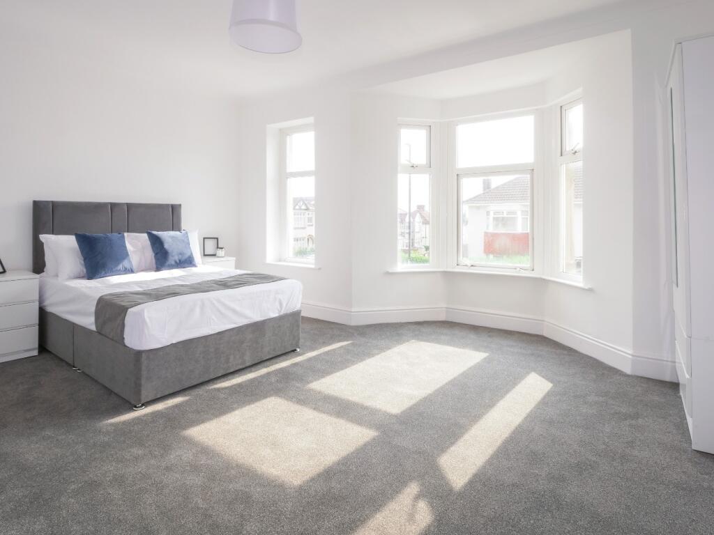 Bright and spacious master bedroom featuring a ...