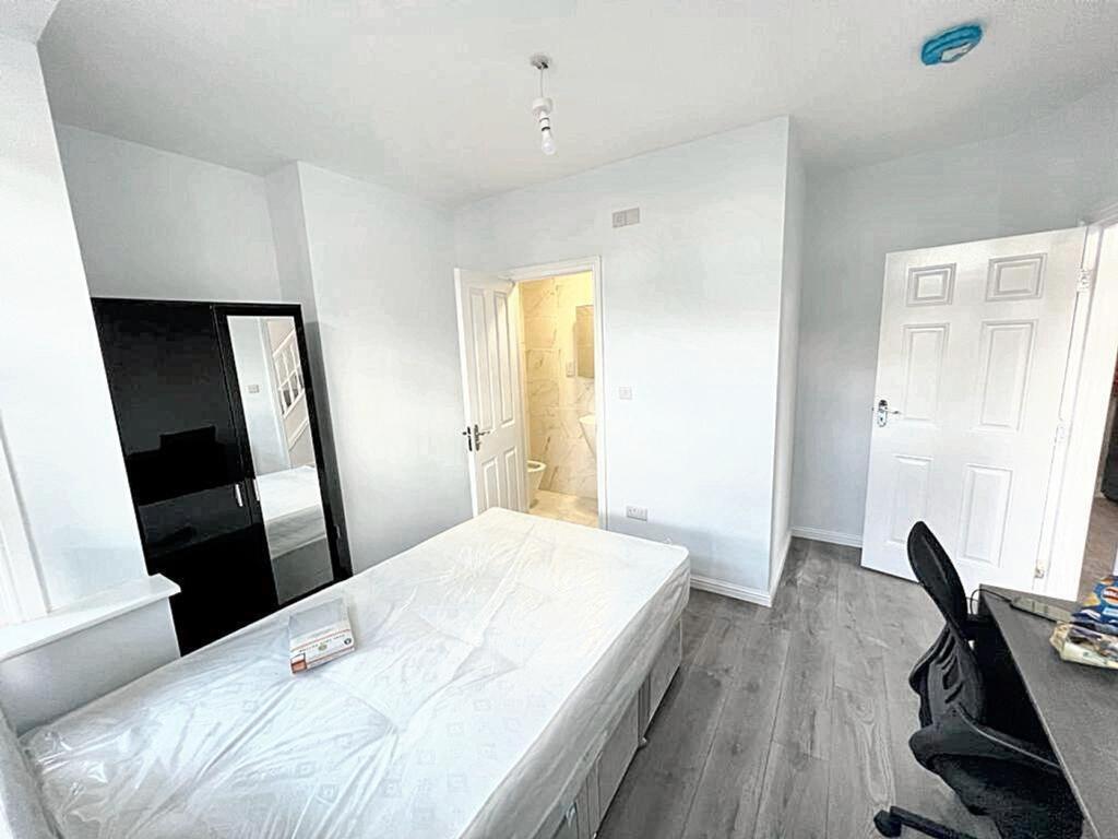 A bright and spacious double bedroom featuring ...