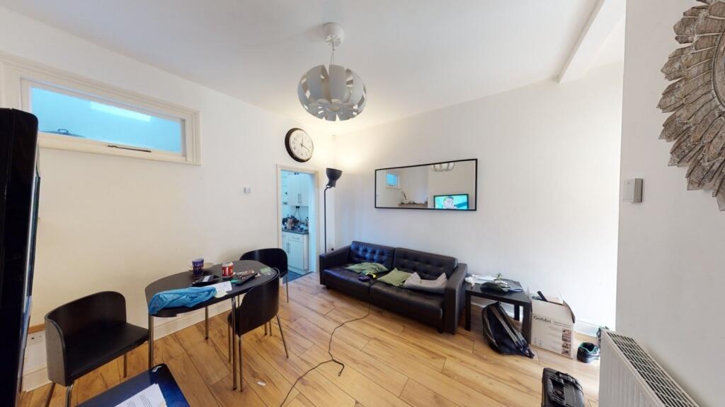 A contemporary living room with wooden flooring...