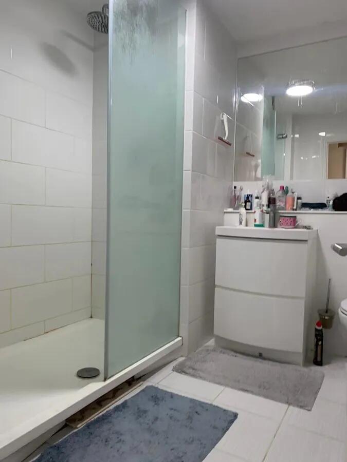 Bright and modern bathroom featuring a walk-in ...