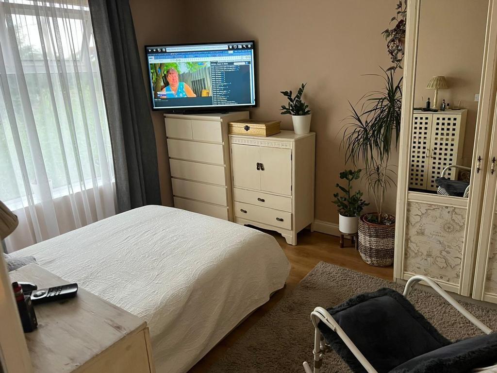 A cozy double bedroom featuring a neatly made b...