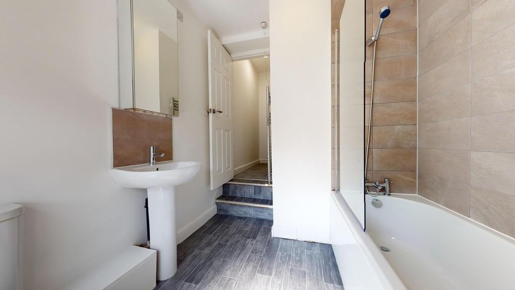 Bright and modern bathroom featuring a clean wh...