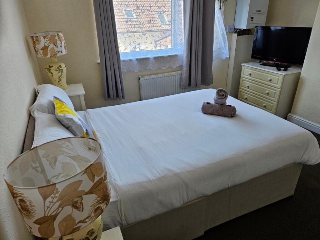 A bright and inviting double bedroom with ample...