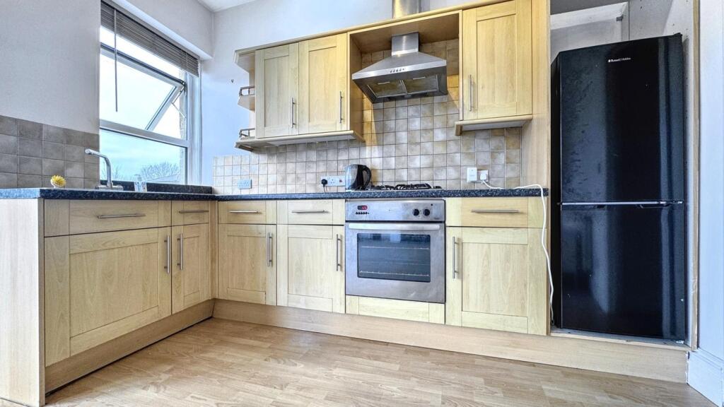 This modern kitchen features ample storage with...