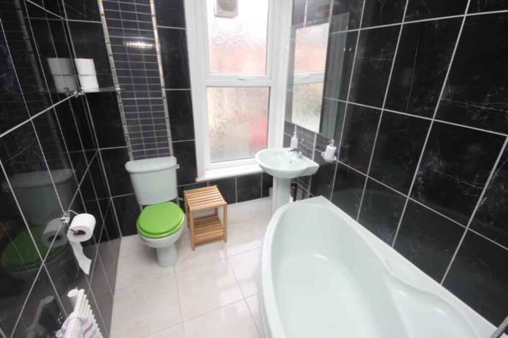 A modern bathroom suite featuring a contemporar...