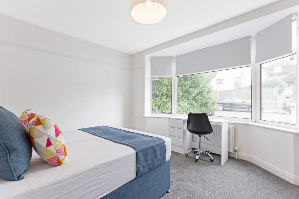 Bright and airy double bedroom featuring a comf...