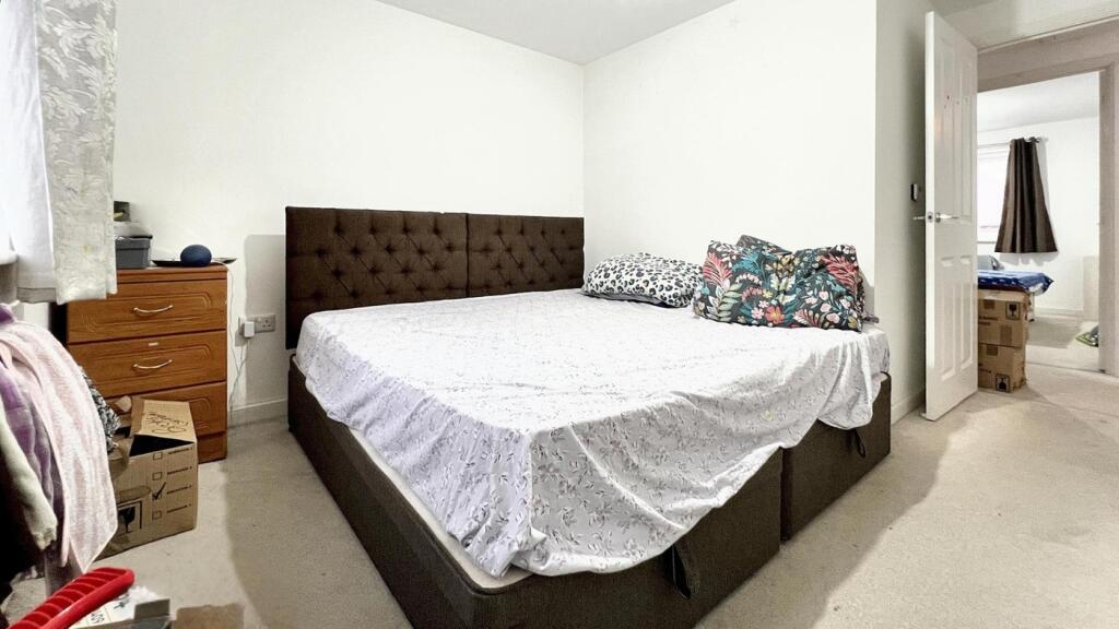 A spacious and inviting double bedroom with coz...