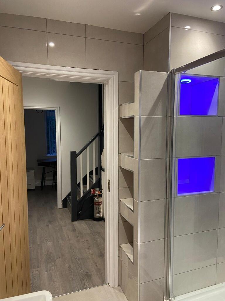 Modern bathroom with a walk-in shower featuring...