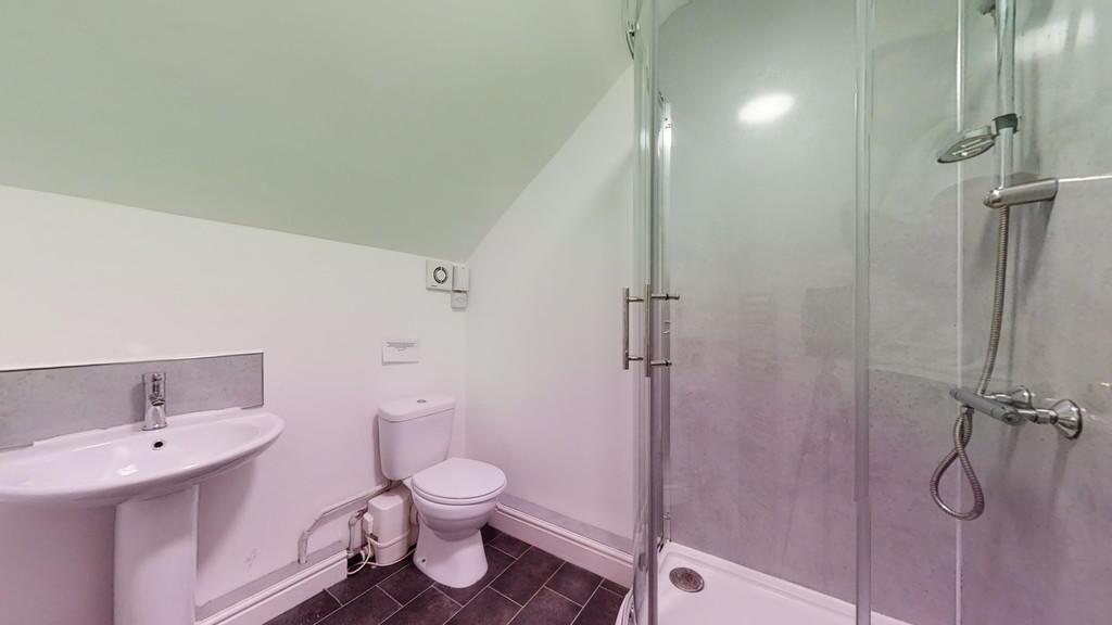 A clean and modern bathroom suite featuring a s...