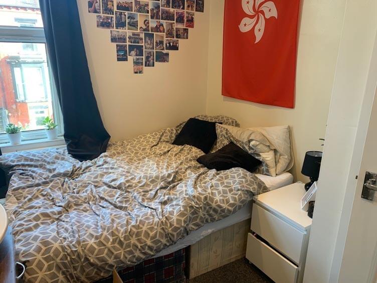 Cozy bedroom featuring a double bed with a deco...