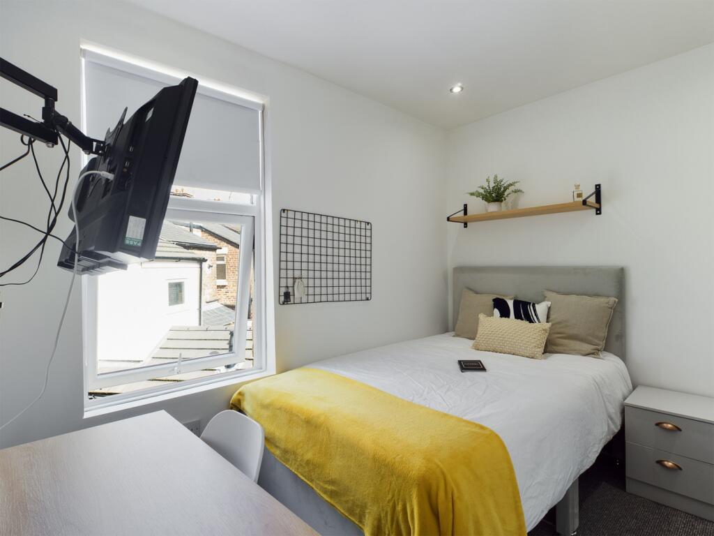 A bright and inviting double bedroom featuring ...