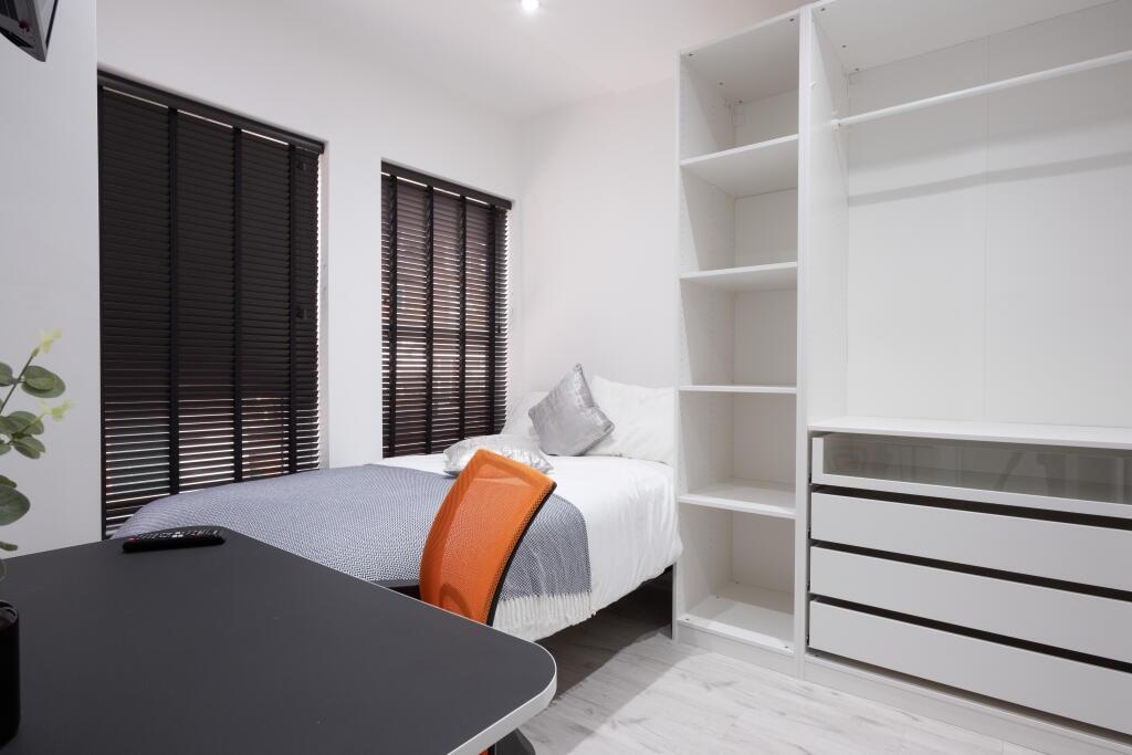 This inviting double bedroom features contempor...