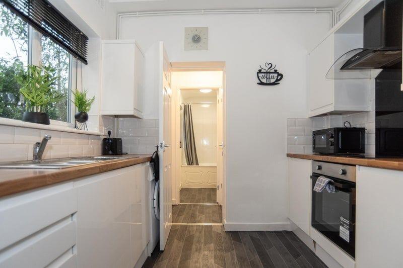 Bright and modern kitchen with sleek white cabi...