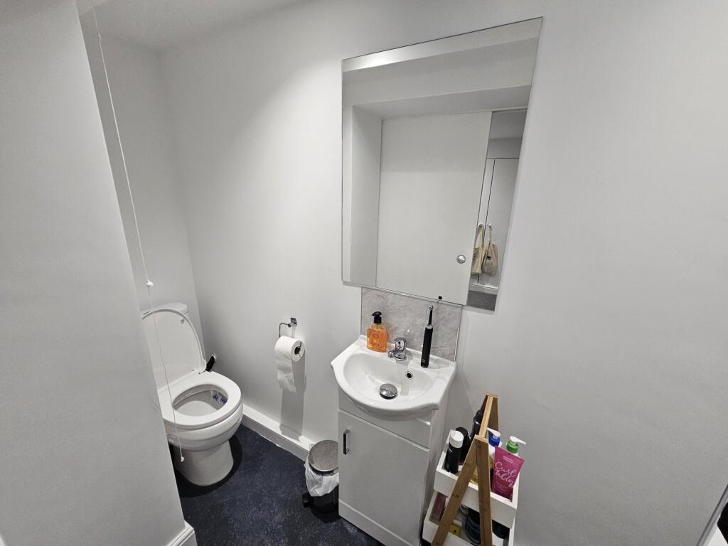 A spacious and modern bathroom featuring a larg...
