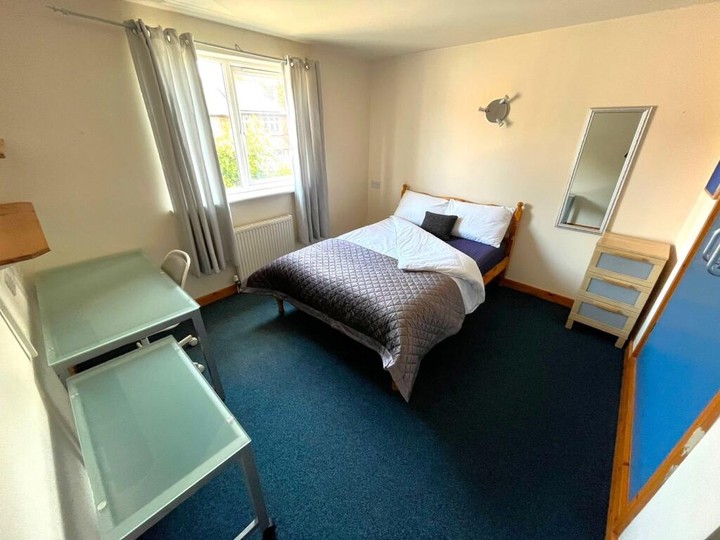 A bright and inviting double bedroom featuring ...