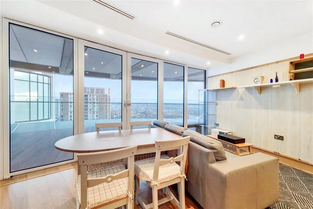Bright and modern living room featuring a styli...