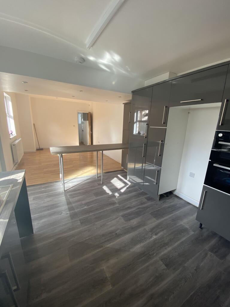 Modern kitchen with sleek grey cabinetry, ample...