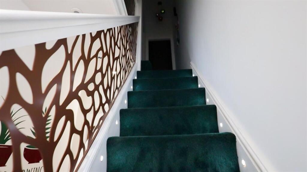 A clean and well-maintained staircase featuring...