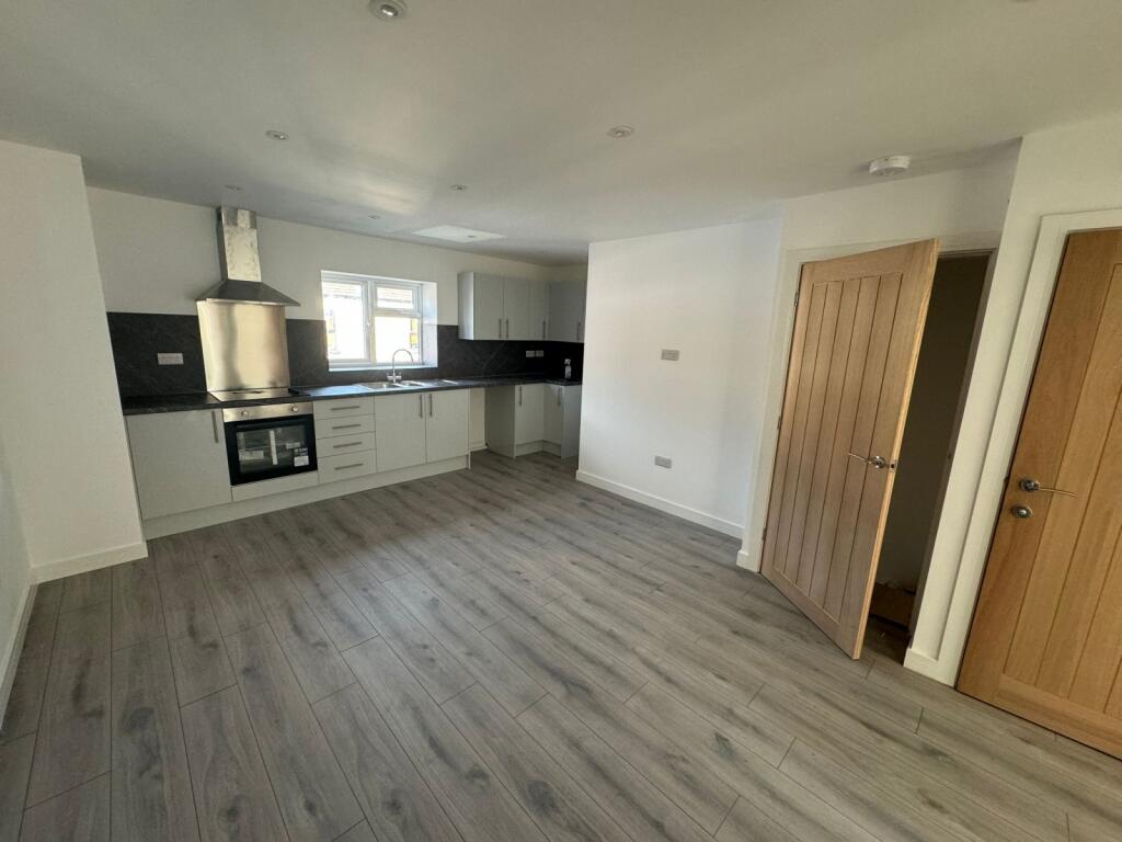 Bright and modern kitchen with sleek white cabi...