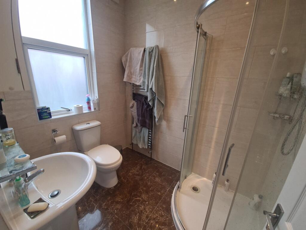 Bright and clean bathroom featuring a walk-in s...