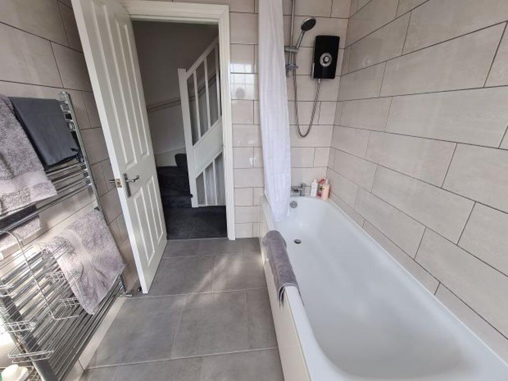 A modern and tidy bathroom featuring a clean ba...