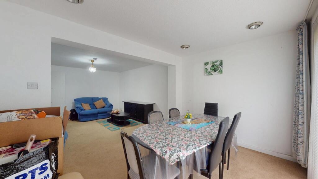 A spacious and well-lit living room featuring a...