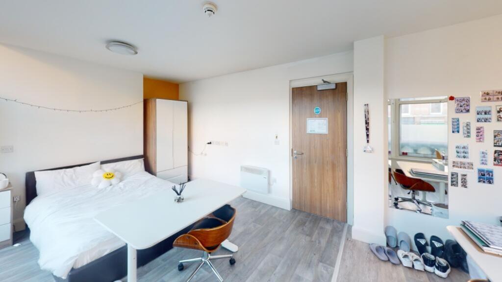 This spacious double bedroom features large win...