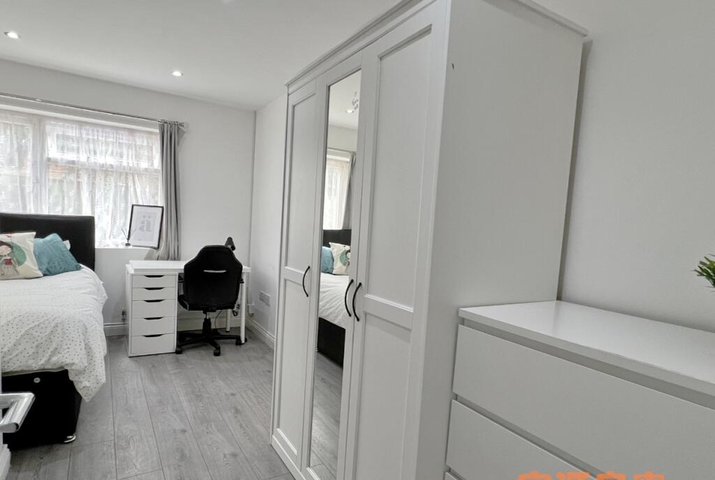 A bright and tidy single bedroom featuring a co...