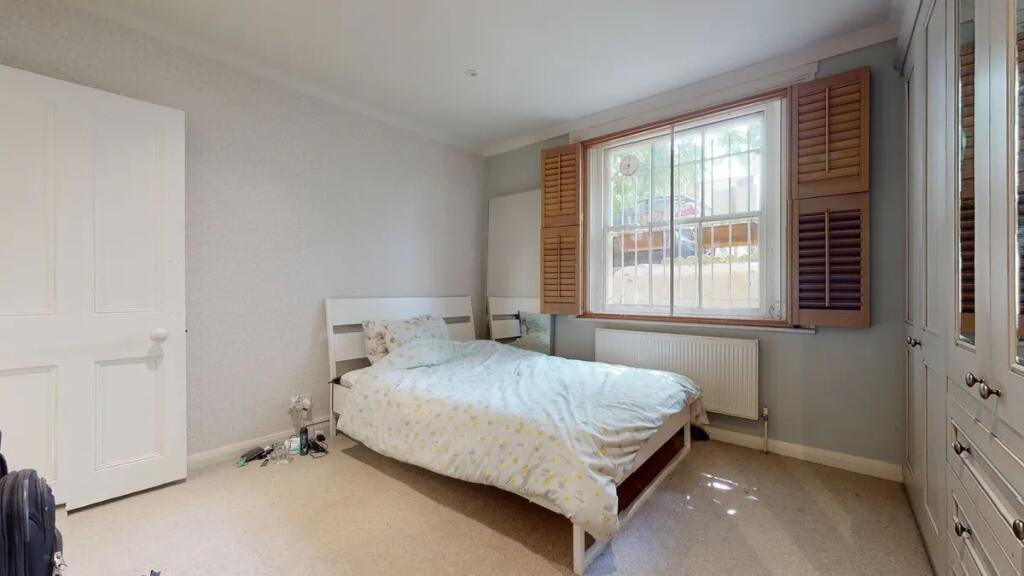 Bright and tidy double bedroom featuring a comf...